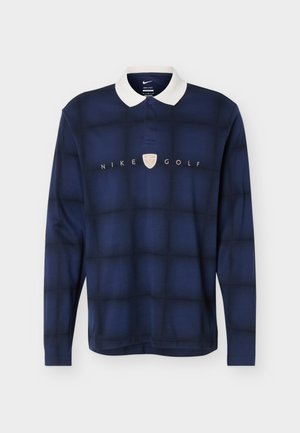 Tengerészkék hosszú ujjú golf póló fehér gallérral, finom kockás mintával és a mellkas közepén elhelyezett „NIKE GOLF” logóval.
