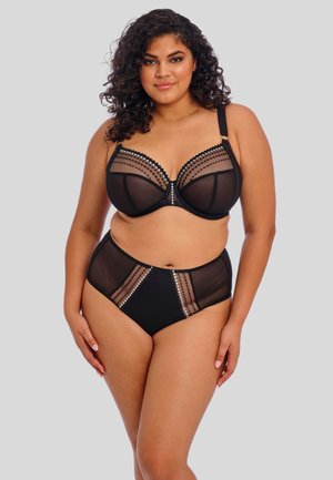Zwart lingerieset met een doorzichtige bh met stippenaccenten en een bijpassende hoge taille slip met versieringen en mesh-paneeltjes.