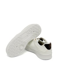 White sneakers featuring a smooth leather upper, rounded toe, and a patterned rubber sole. Black accent on the heel with branding.
