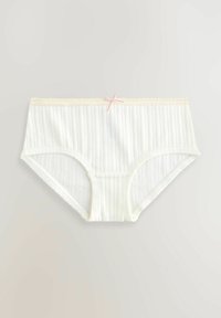 Boxer bianchi in cotone a coste con un accento a fiocco rosa in vita. Tessuto morbido e materiale elastico, progettati per il comfort.