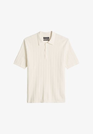 Korte mouwen crème geribd polo met drie knopen en een zachte kraag van biologisch katoen.
