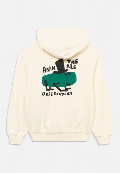 Sweat à capuche crème avec un lézard vert stylisé portant un haut-de-forme noir et le texte "Animals Observatory" dans le dos.