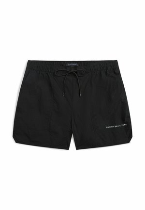 Bañador corto negro para hombre con cintura elástica, cordón negro y logo blanco de Tommy Hilfiger en la pierna izquierda.