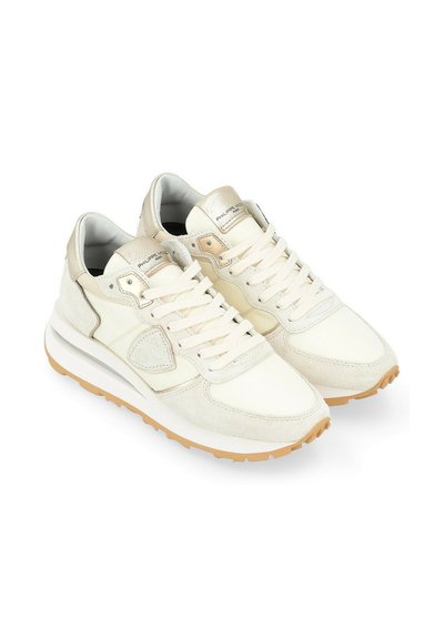 Sneakers in cream and tan, featuring a mix of leather and suede, with a textured design, round toe, and cushioned sole.