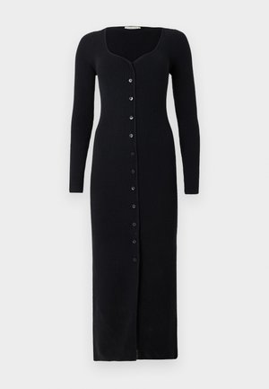 Long black ribbed dress with a curved neckline, long sleeves, and front buttons down the center. Features a snug fit and floor-length design.