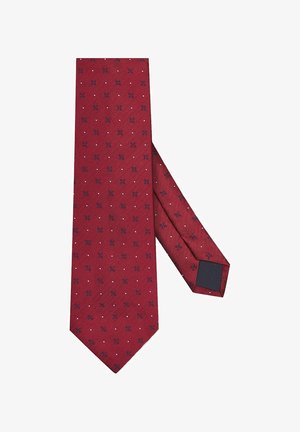 Czerwona muszka w wzór rybiej ości, z małymi granatowymi geometrycznymi kształtami i białymi kropkami. Gładka tekstura z jednolitą czarną stroną wewnętrzną.