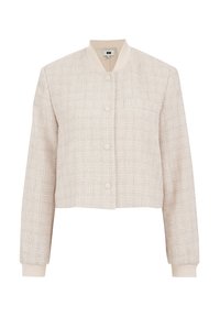 Veste courte en tissu beige clair texturé, avec un col rond, une fermeture à boutons, des poignets côtelés et une poche poitrine.
