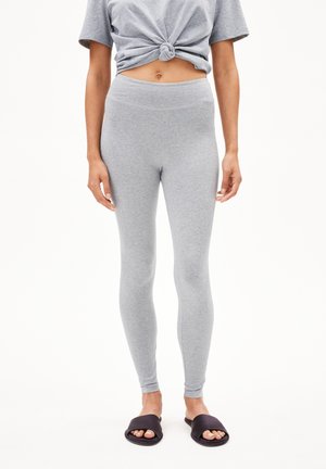 Gray cotton leggings with a smooth texture and high waist. Paired with a knotted short-sleeve gray top and black slide sandals.