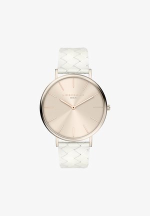 Rund ur med et poleret roséguldfarvet metalhus, beige urtavle og minimalistiske time-markeringer. Har en struktureret hvid vævet læderrem.