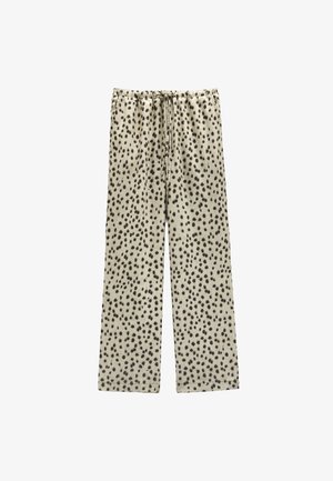 Kremowe spodnie o luźnym kroju z czarnym wzorem w kropki, elastycznym pasem i detalem w postaci sznureczka. Miękka tekstura materiału.