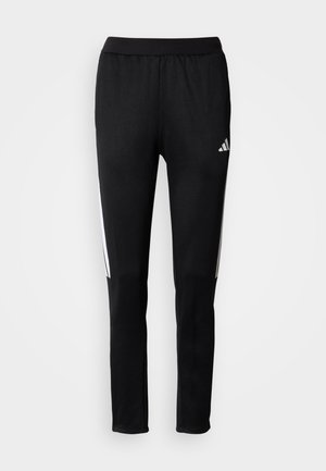 Black athletic pants with elastic waistband, featuring white side stripes and the Adidas logo on the left thigh. Smooth, stretchy fabric.