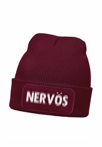Maroon knit beanie with a turned-up cuff featuring a rectangular label with the text "NERVÖS" in white. Ribbed texture throughout.