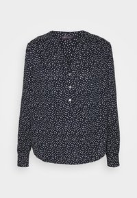 Marineblaue Bluse mit einem weißen Punktmuster, V-Ausschnitt, Knopfleiste, langen Ärmeln mit knöpfbaren Manschetten und einem lockeren Schnitt.