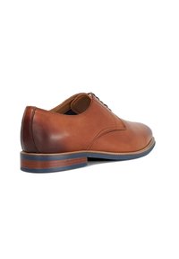 Tan leather dress shoe with a smooth finish, rounded toe, and lace-up design. Features a wooden heel with a blue accent strip.