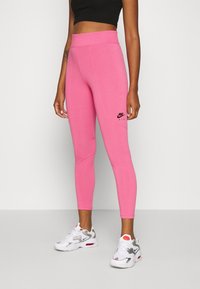 Rosa, figurnära leggings med hög midja och sydda detaljer, med en liten svart Nike Air-logotyp på höftområdet.