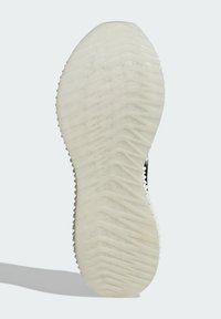 Shoe sole with a textured, waved surface in off-white rubber, featuring grooves for traction. The edges are slightly raised.