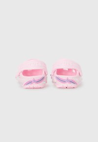 Pink Crocs with transparent accents, featuring a rainbow star design, open back, and comfortable, lightweight material.