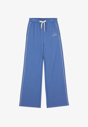 Blauwe sweatpants met wijde pijpen, witte zijstrepen, een elastische tailleband, een witte trekkoord en een klein geborduurd "Polo Club" logo op de linkerheup.