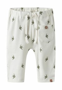 Ljusbeige ribbade shorts med grön fågeltryck, elastisk midja, justerbar dragsko och sidoficka med detaljer i träknapp.