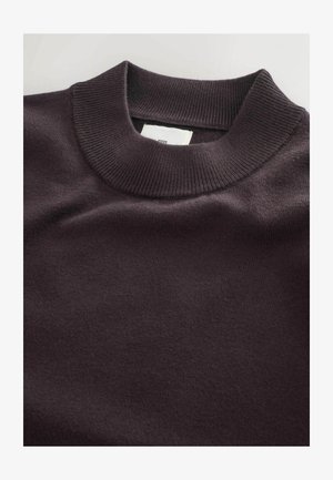 Dark purple sweater featuring a ribbed crew neck, soft texture, and a smooth finish. Label visible at the neckline inside.