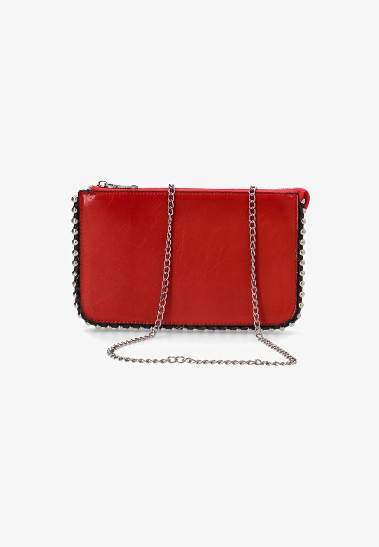 Bolso de mano de cuero sintético rojo con cadena plateada, ribete negro y tachuelas redondas a lo largo de un lado. Cierre de cremallera en la parte superior.