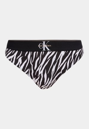 Black and white zebra-striped Calvin Klein underwear with black waistband and white logo centered on the front.