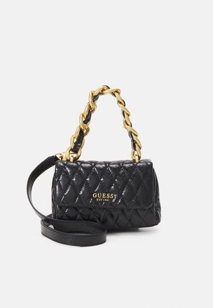 Black quilted leather Guess purse with gold chain handle and long black strap, logo and "EST 1981" in gold lettering on front flap.