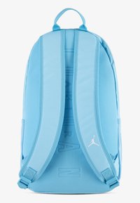 Light blue backpack with padded straps, textured fabric, a top handle, and a white Jordan logo on the lower right side.