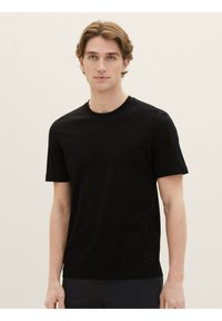 Black short-sleeve t-shirt made of soft fabric, featuring a crew neckline and a small logo detail on the bottom left.