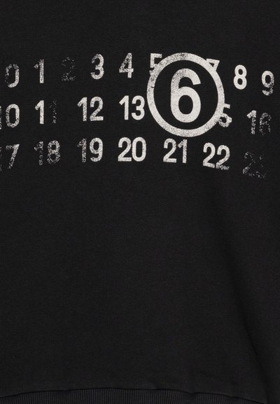 Black sweatshirt featuring a white, distressed number pattern, with the number 6 prominently enclosed in a circle. Soft, textured fabric.