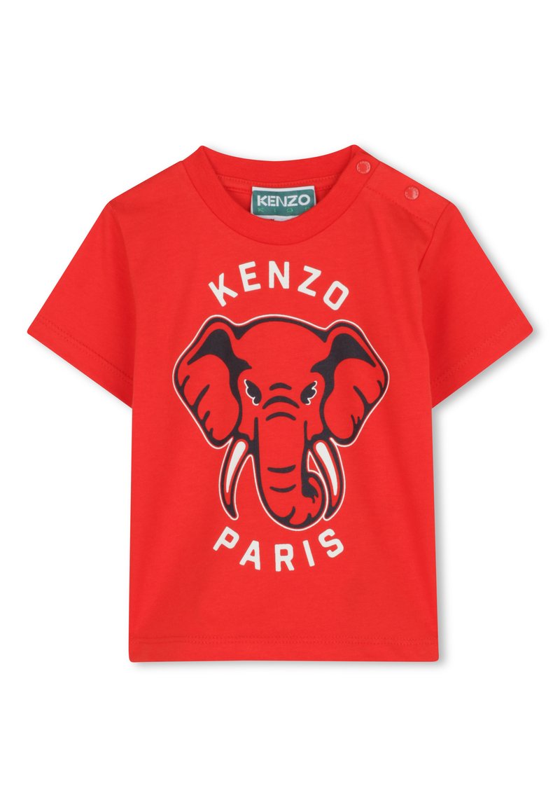 T-shirt en coton rouge avec un graphique d'éléphant aux contours noirs, texte "KENZO" et "PARIS" en dessous. Deux pressions sur l'épaule pour un habillage facile.