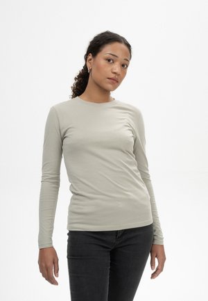Langärmliges, hellgraues Shirt aus einem weichen, leichten Jersey-Stoff. Eng anliegendes Design mit rundem Halsausschnitt und subtiler Dehnung.