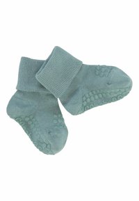 Chaussettes pour bébé bleu-vert avec revers et semelles en caoutchouc antidérapantes.