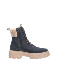 Stivaletto in suede blu scuro con suola in gomma marrone, colletto beige morbido, zip laterale e occhielli metallici per i lacci.