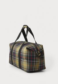 Plaid-patterned travel bag with black handles and gold zipper, featuring green, red, yellow, and white stripes on fabric surface.