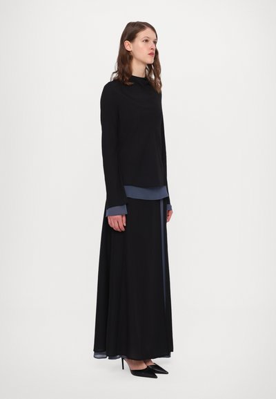 Black long-sleeve dress with layered blue accents, featuring a high neckline and flared silhouette, crafted from lightweight fabric.