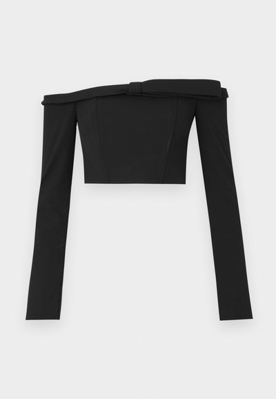 Black off-the-shoulder cropped top with long sleeves, featuring a structured design and knot detailing at the neckline, made of smooth fabric.