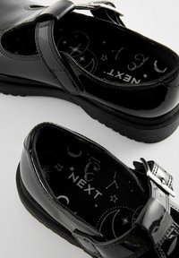 Zwarte gepatineerde leren Mary Jane-schoenen met een verstelbare band, ronde neus en een textuurinterieur met sterrenhemelpatronen.