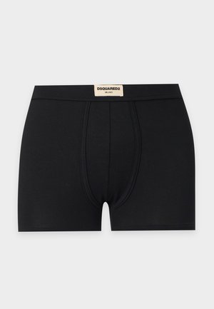 Boxer noir pour homme avec une poche avant profilée et une étiquette beige sur la ceinture portant l'inscription DSQUARED2 MILANO.