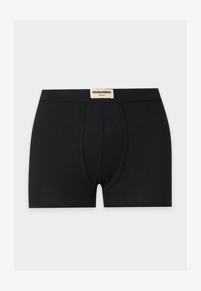 Boxer noir pour homme avec une poche avant profilée et une étiquette beige sur la ceinture portant l'inscription DSQUARED2 MILANO.