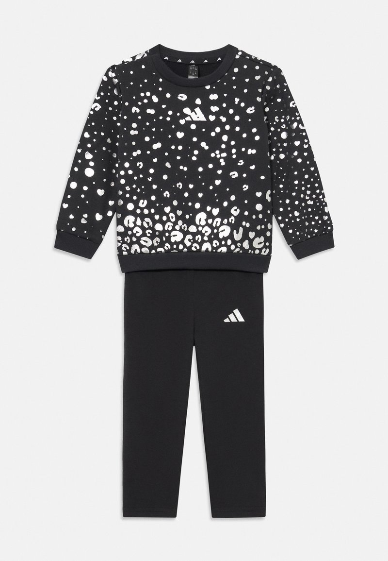 Black sweatshirt with silver leopard print, crew neck, and ribbed cuffs, paired with black pants featuring a small white Adidas logo.