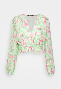 Häkelbluse aus transparenter Stoff mit einem mehrfarbigen abstrakten Blumenmuster in Grün, Pink und Weiß. Mit langen Ärmeln und V-Ausschnitt.