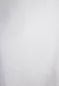 White fabric featuring a smooth texture with a subtle sheen. Includes small embroidered "Mexx" logo in a contrasting tone.