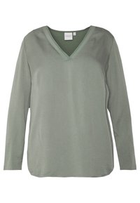 Maglia a maniche lunghe di un verde tenue, con scollo a V e una texture liscia e morbida. Il design ha una vestibilità comoda e un orlo leggermente curvato.