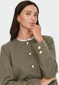 Brown houndstooth-patterned jacket with a crew neckline and gold buttons on the front and sleeves. Textured fabric with a structured fit.