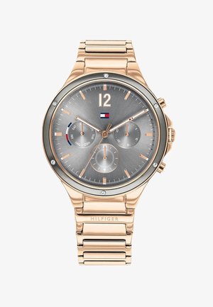 Roosa kuldne kroonograafikell halli numbrivahega, araabia numbriga 12, kolme alassekundiga ja ühendatud käevõruga. Omab logo ja selgeid kristalle.