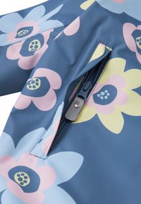 Chaqueta con estampado floral en tonos de azul, que presenta flores rosas y amarillas. Incluye un bolsillo con cremallera y herrajes en azul oscuro.