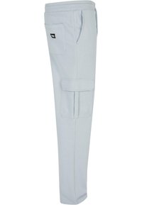 Light blue sweatpants made of soft fabric, featuring a side cargo pocket, elastic waistband, and ankle cuffs for a tapered fit.