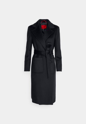 Black wool coat with a belted waist, large lapels, and two front pockets. Features a smooth texture and red inner lining.