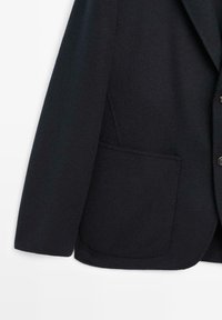 Navy wool blazer featuring a structured design, notch lapels, and a single patch pocket on the front with button closures.